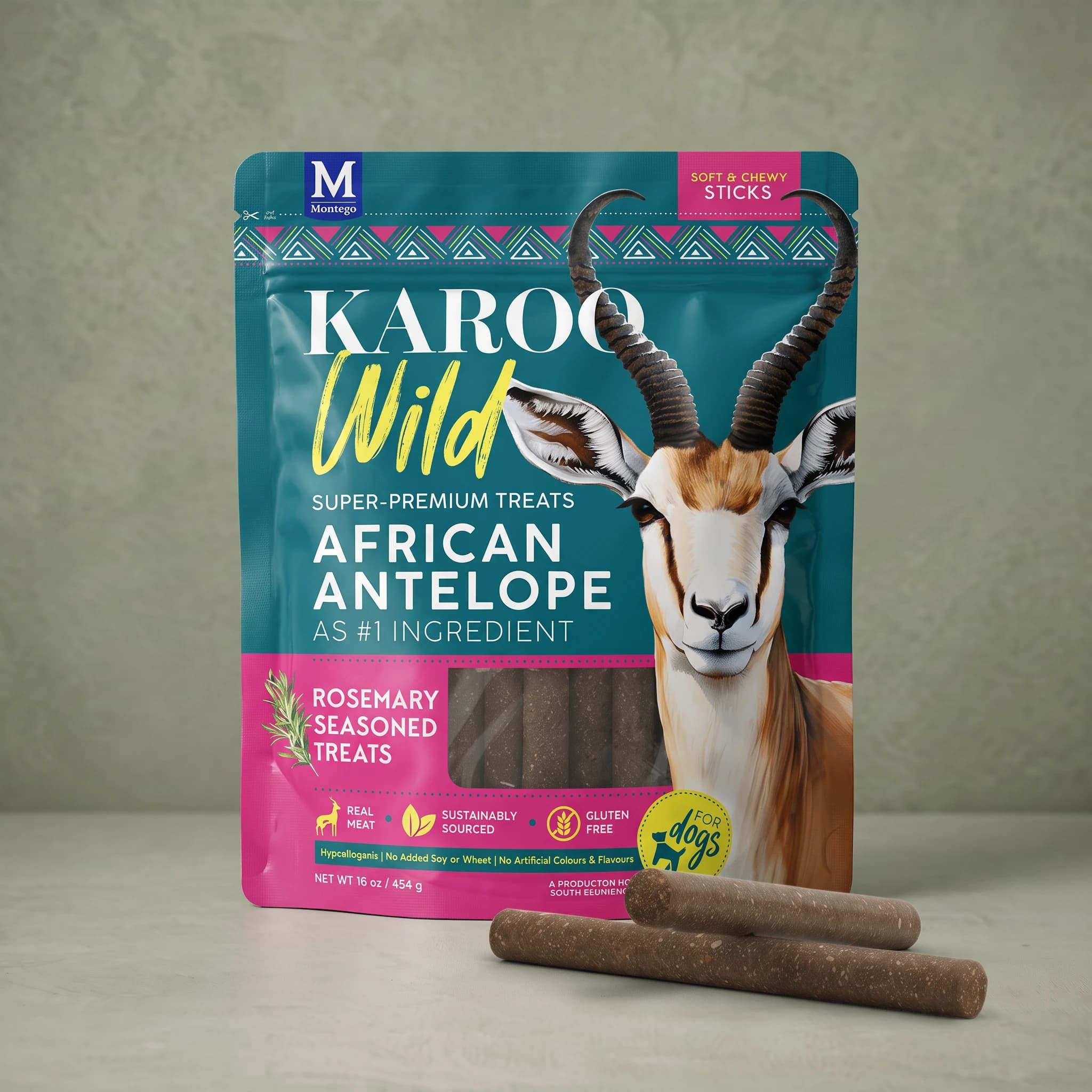 The same teal and magenta Karoo Wild Rosemary Sticks pouch standing upright against a plain sage green background, with two dark brown chewy sticks crossed at its base.