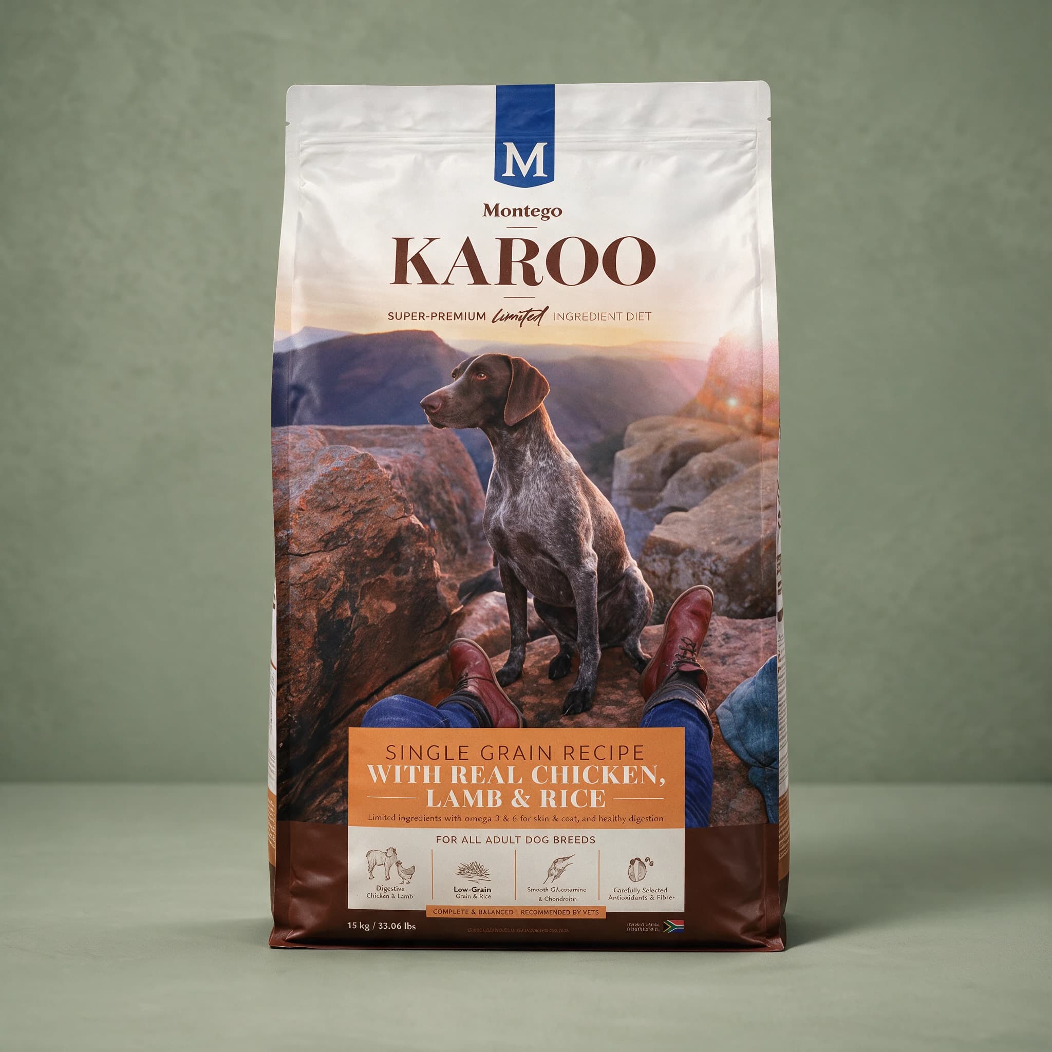 A white stand-up pouch of Montego Karoo dry dog food with a navy "M" Montego logo and brown "KAROO" wordmark, labelled "Super-Premium Limited Ingredient Diet," showing a lifestyle photo of a dog with its owner at golden hour and a banner reading "Single Grain Recipe with Real Chicken, Lamb & Rice,"