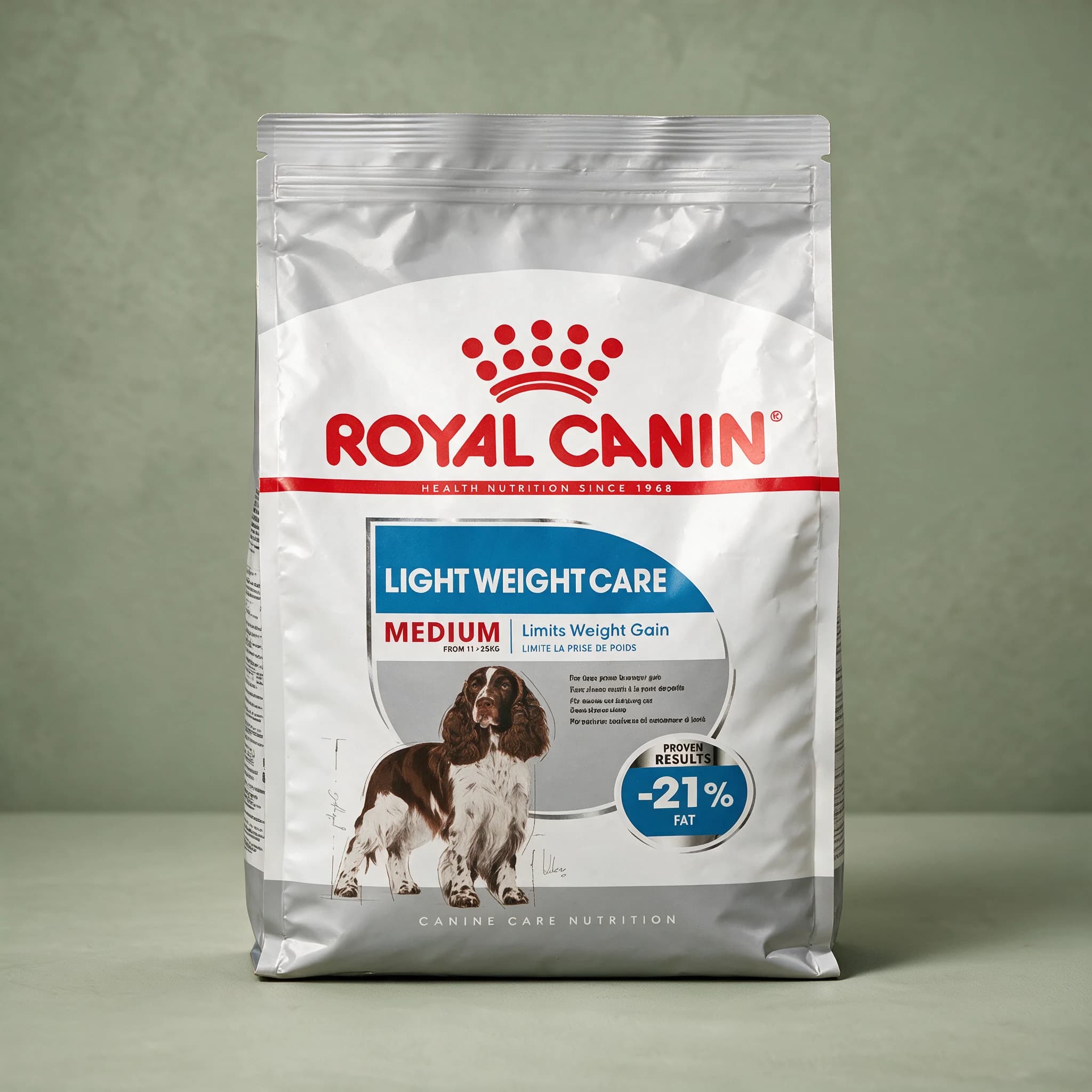 The white Royal Canin Light Weight Care Medium Adult dry dog food bag, featuring a medium-breed dog illustration and "Light Weight Care" callout, photographed against a plain sage green studio background.