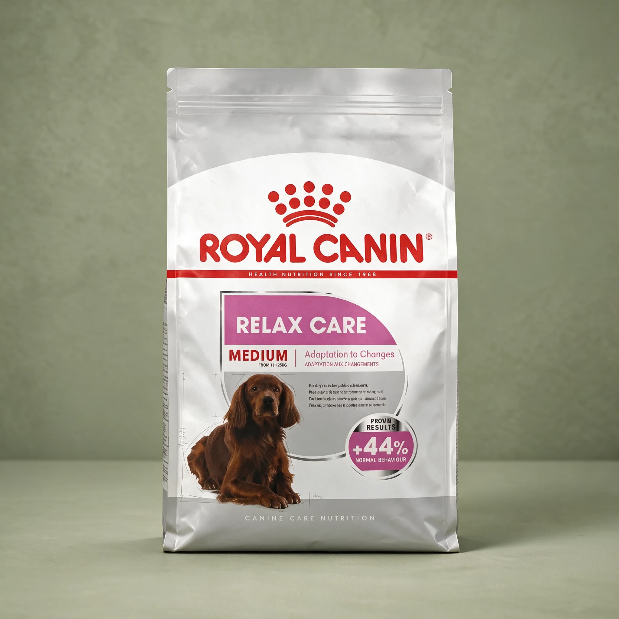 The white Royal Canin Relax Care Medium Adult dry dog food bag with a purple "Relax Care" banner, featuring a medium-breed dog illustration and a "+44% Normal Behaviour" callout, photographed against a plain sage green studio background.