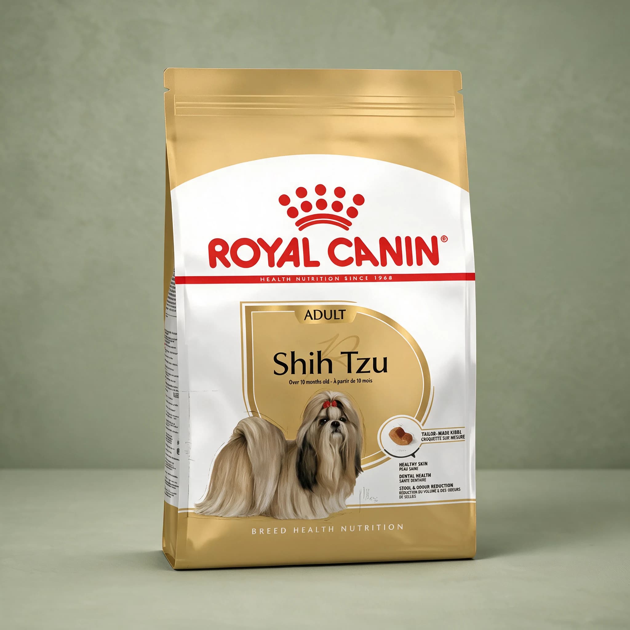 A gold and white Royal Canin Shih Tzu Adult dry dog food bag with an illustrated Shih Tzu wearing a red bow, "Breed Health Nutrition" branding, and healthy skin, dental health, and stool/odour reduction callouts, photographed against a plain sage green studio background.